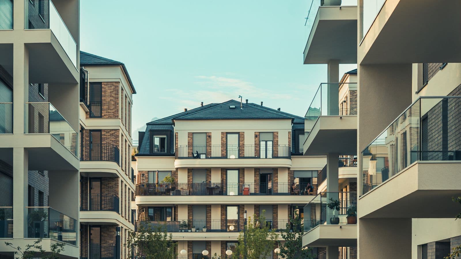 Contemporary residential blocks with balconies around a landscaped courtyard.